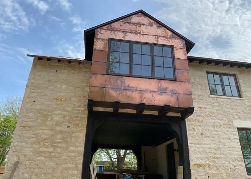 Copper metal panel facade on a stone building for Skylight Installation in Pooler